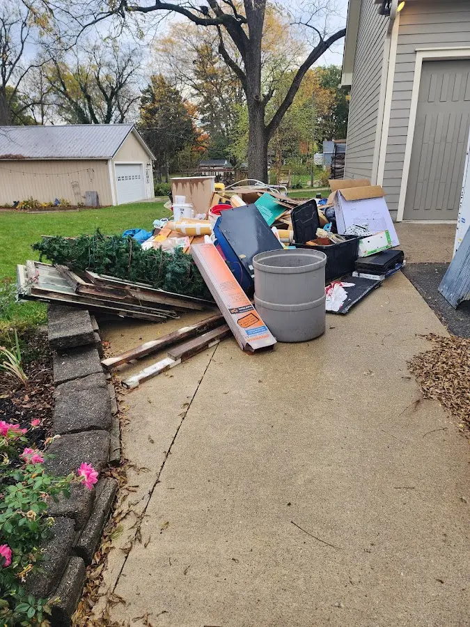 Dumpster being loaded with debris for 10 Yard Dumpster Rental in Mannford